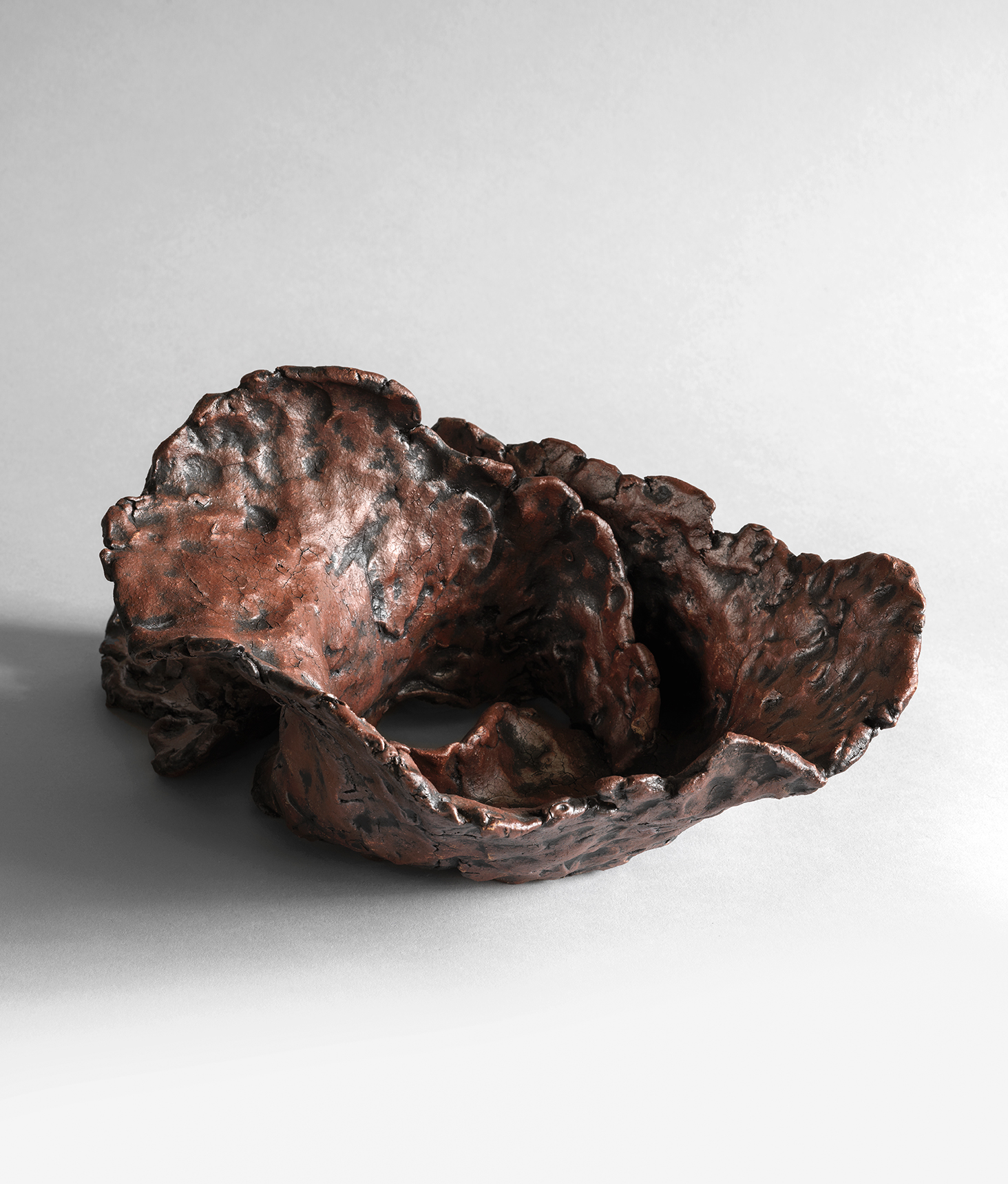 stoneware sculpture with organic swirling forms and hollow interior spaces