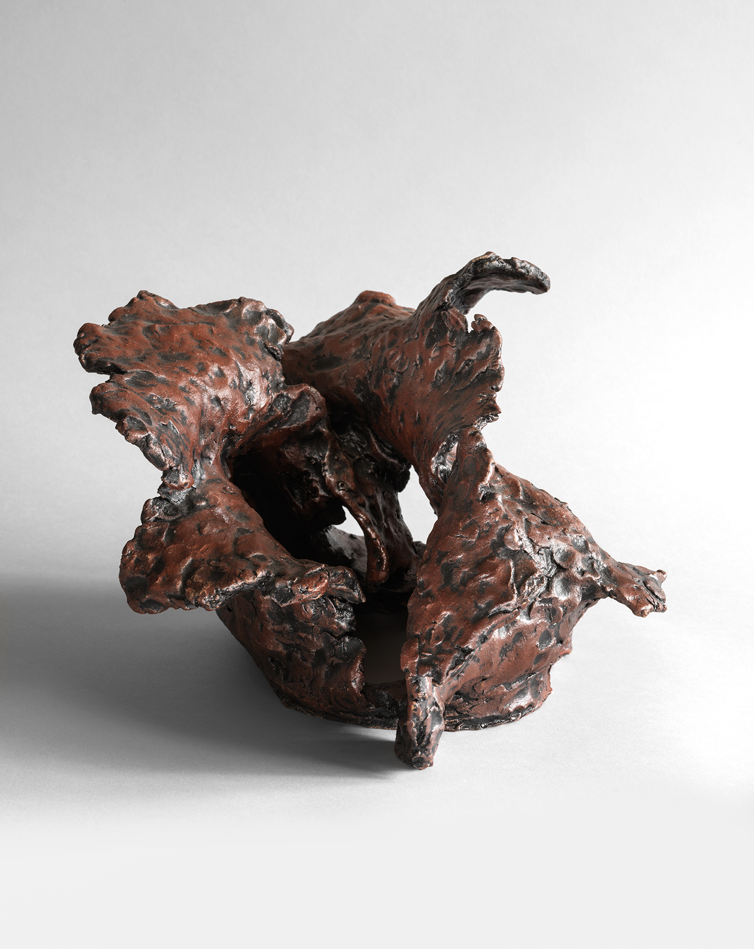 Angular stoneware sculpture with vertical jagged forms and sharp crystalline projections